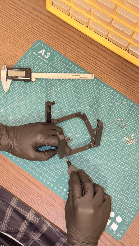 Assembly work with screwdriver on cutting mat