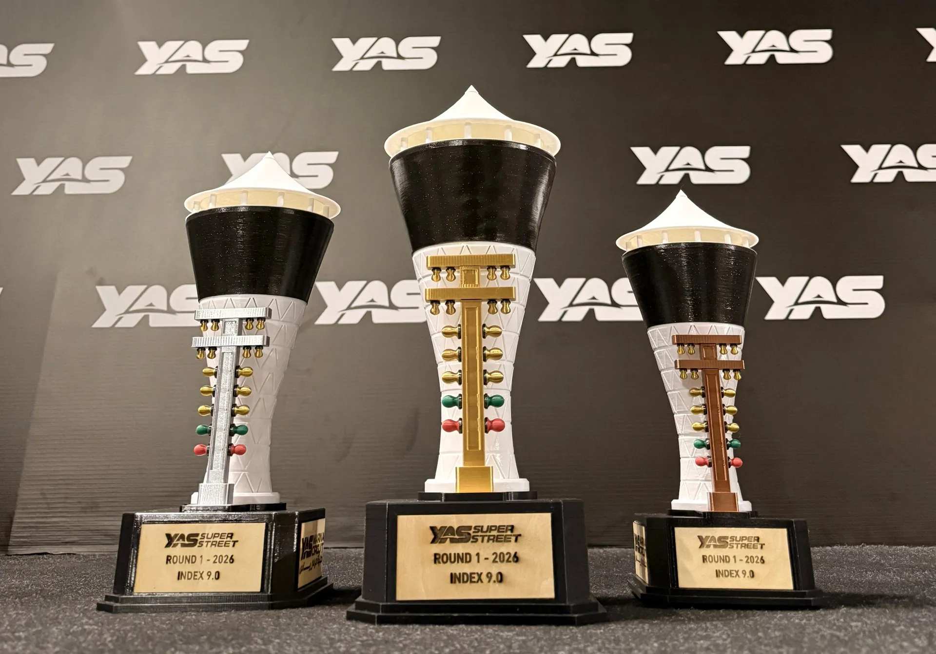 YAS Super Street trophies with gold, silver, and bronze racing tree ornaments
